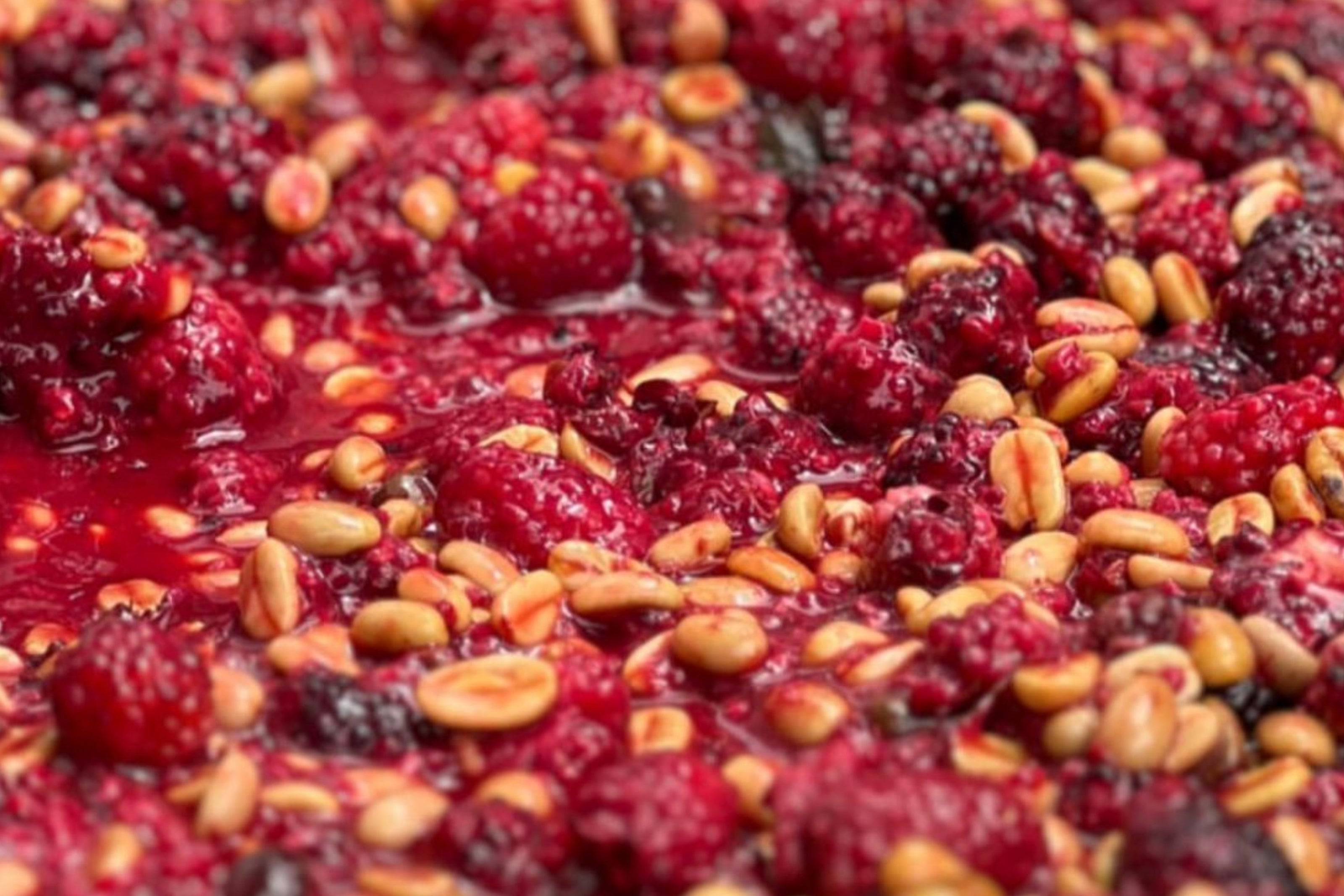 Close-up of a mixture of berries and coffee beans. Co-fermented red bourbon from teh coffee reagion in Colombia.